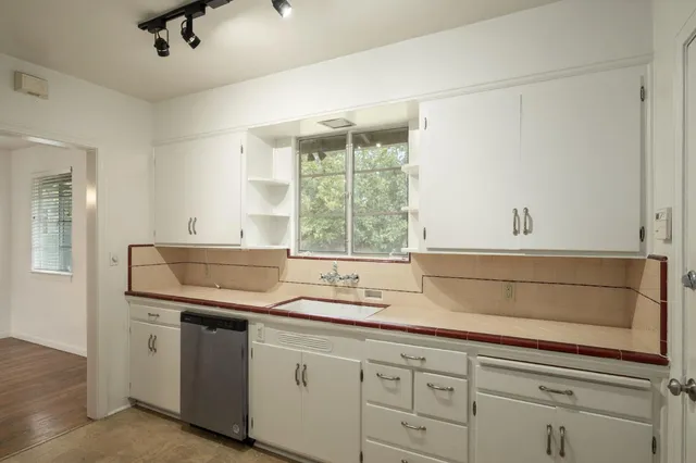 a kitchen with granite countertop a sink and a window