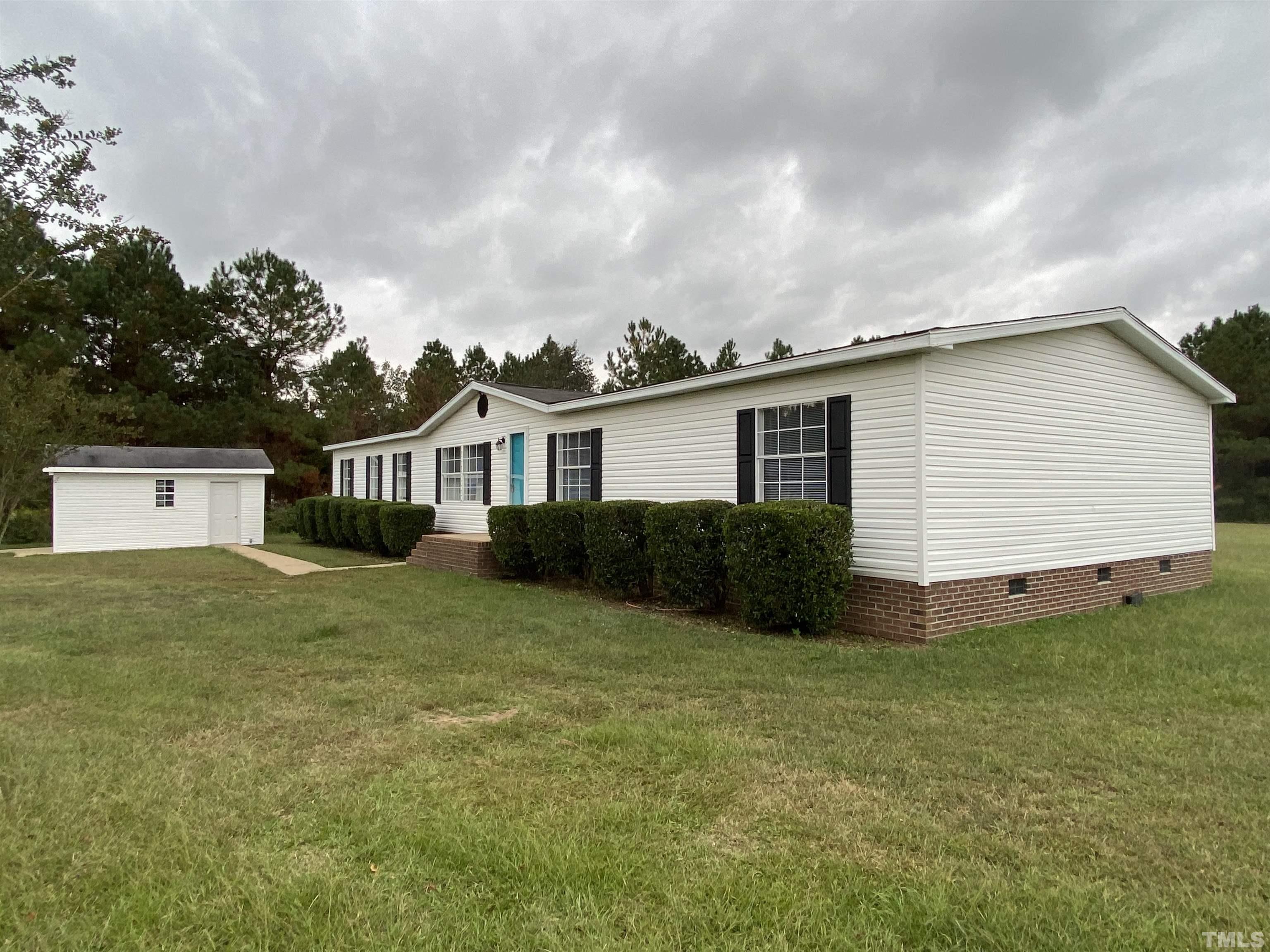 9969 Smith Road Middlesex, NC 27557 - Photo 3 of 19 a view of a house with a yard and garage