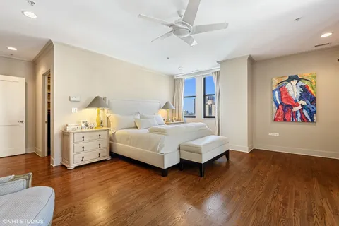 a bedroom with a large bed and a chandelier