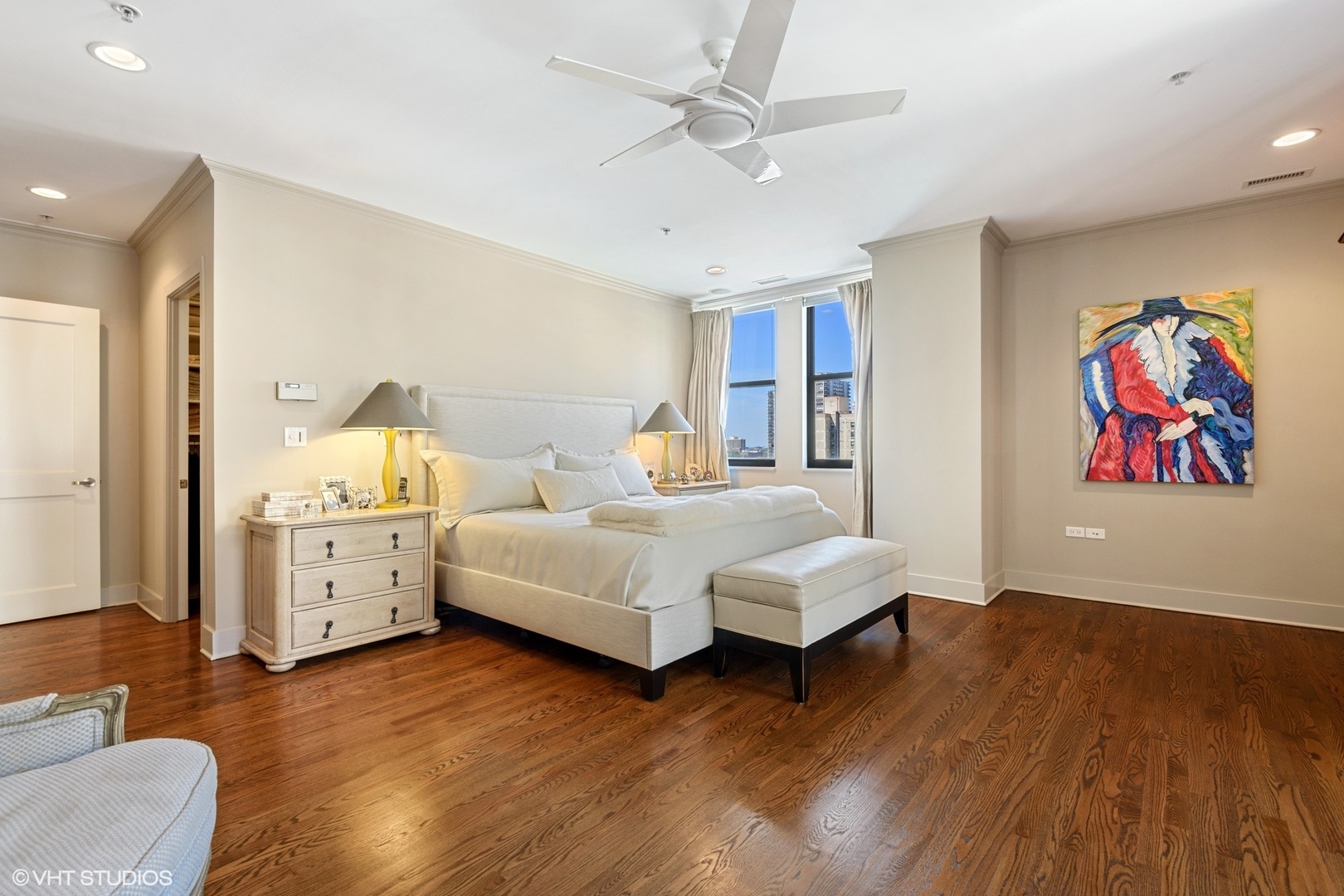 1155 North Dearborn Street, Unit 1003 Chicago, IL 60610 - Photo 12 of 28 a bedroom with a large bed and a chandelier