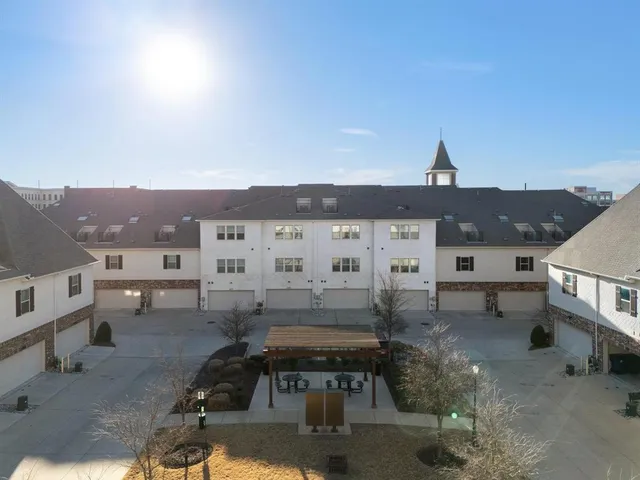 an aerial view of multiple houses with a yard