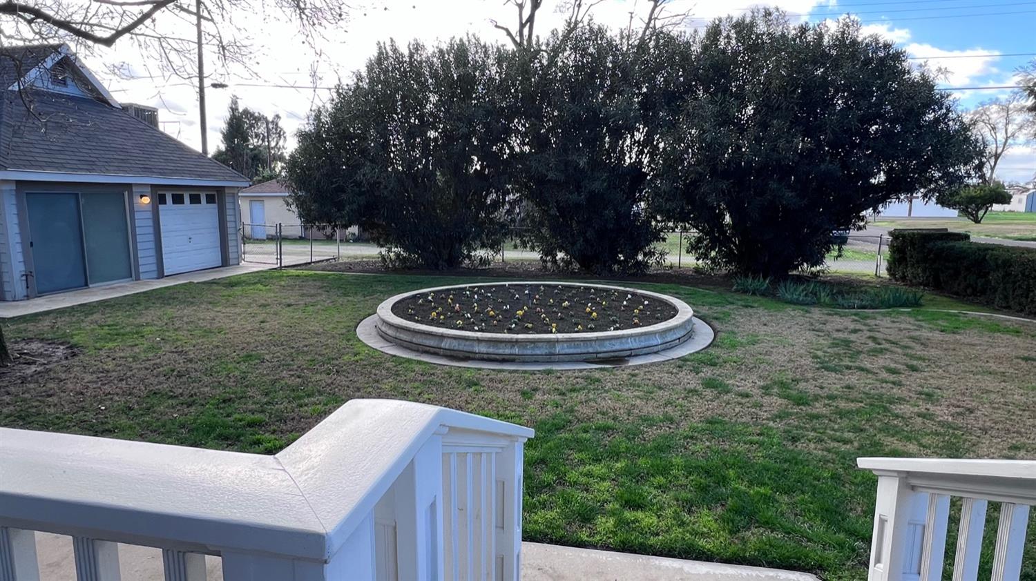 6375 Murphy Avenue Laton, CA 93242 - Photo 62 of 68 a view of a backyard with table and chairs plants and trees