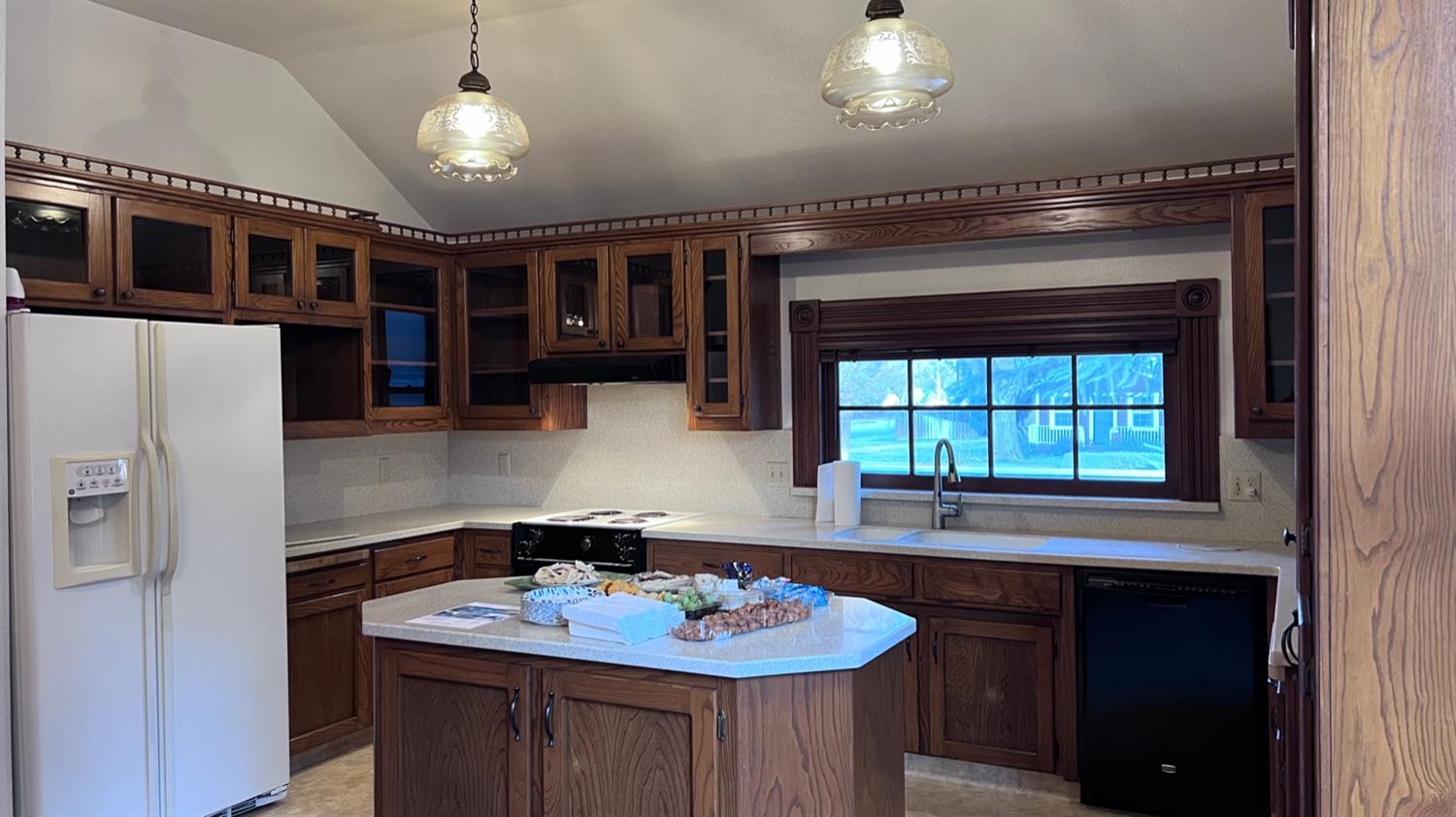 6375 Murphy Avenue Laton, CA 93242 - Photo 10 of 68 a bathroom with a sink a chandelier and a view of living room