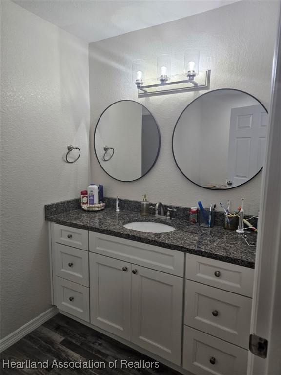 565 Stephens Road Wauchula, FL 33873 - Photo 14 of 36 a bathroom with a granite countertop double vanity sink and mirror