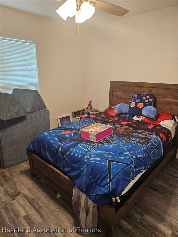 565 Stephens Road Wauchula, FL 33873 - Photo 18 of 36 a bedroom with a bed and a chandelier