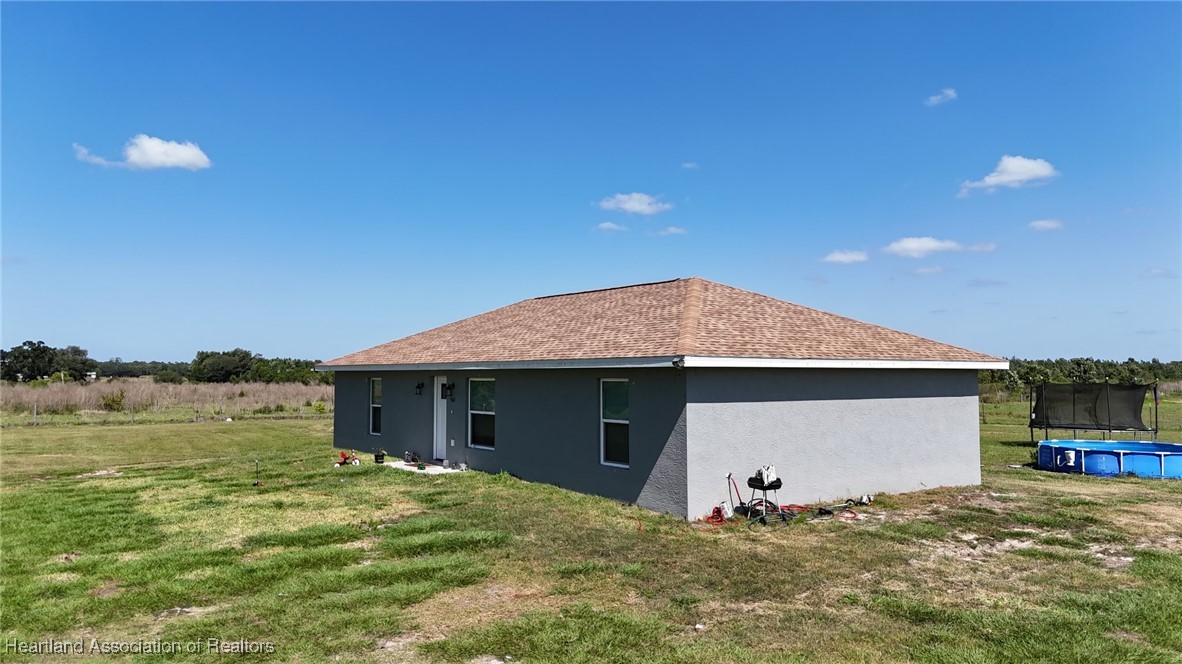 565 Stephens Road Wauchula, FL 33873 - Photo 5 of 36 a front view of a house with a garden and yard