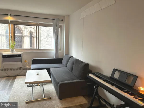 a view of a workspace with furniture and wooden floor
