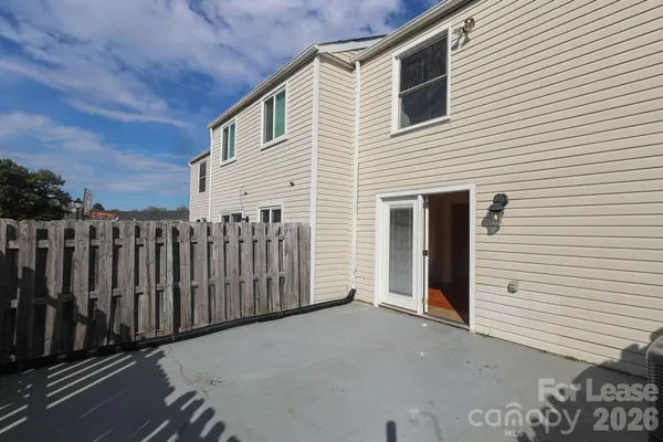 a view of a house with wooden fence