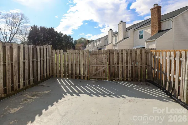 a view of a backyard with wooden fence