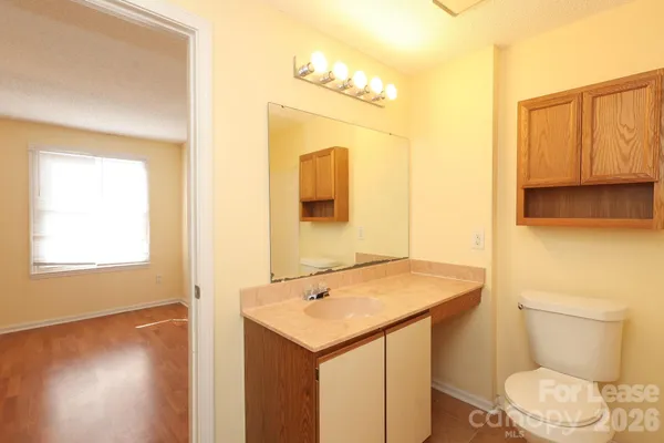 a bathroom with a sink a toilet and mirror