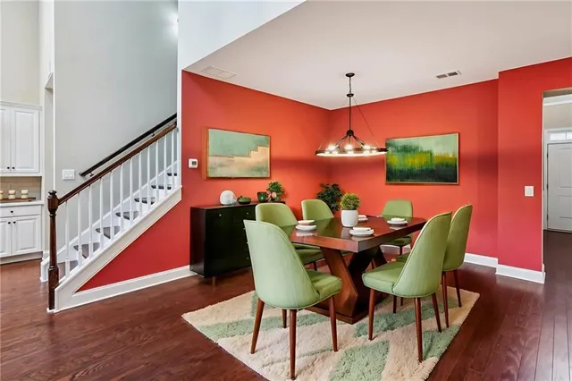 a dining room with furniture a rug and wooden floor
