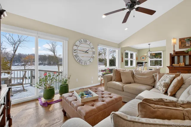 a living room with furniture and floor to ceiling windows