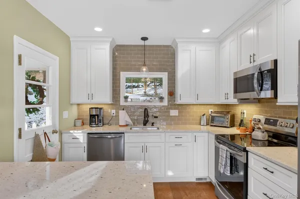 a kitchen with a sink stove top oven and cabinets