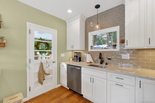 a kitchen with a sink window and cabinets