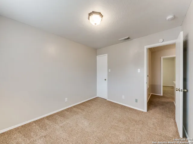 an empty room with a fan