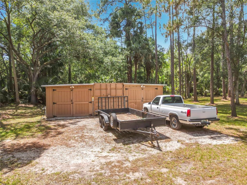 1395 Maytown Road Osteen, FL 32764 - Photo 54 of 65 a backyard of a house with barbeque oven and outdoor seating