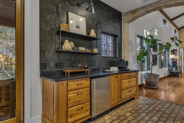 a kitchen with stainless steel appliances granite countertop a sink and cabinets