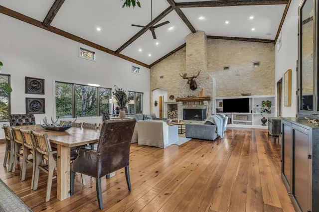 a living room with fireplace furniture and a wooden floor
