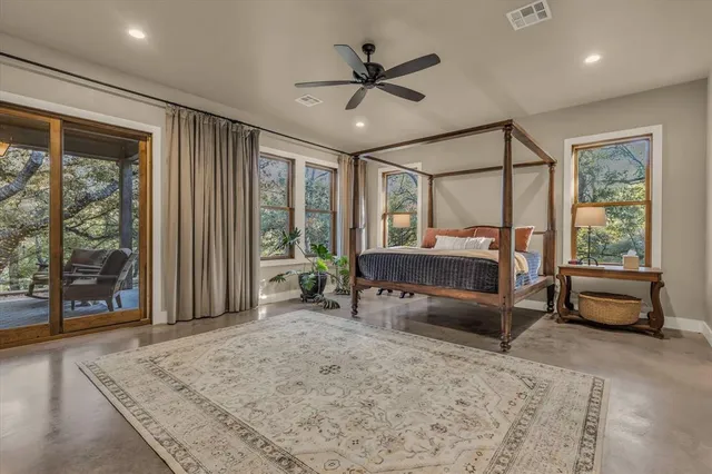 a bedroom with furniture and a large window