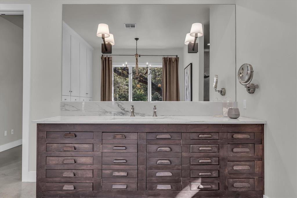 22 Samaritan Way Waco, TX 76705 - Photo 27 of 38 a bathroom with a granite countertop sink and a mirror