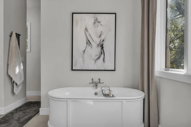 a bathroom with a sink and mirror with window