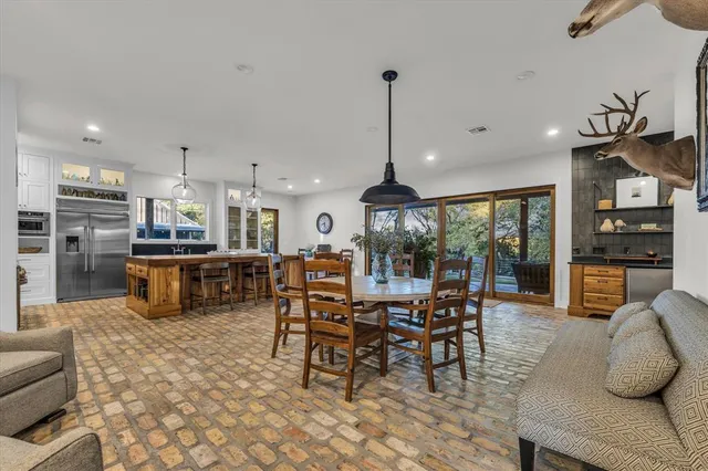 a kitchen with stainless steel appliances kitchen island granite top and refrigerator