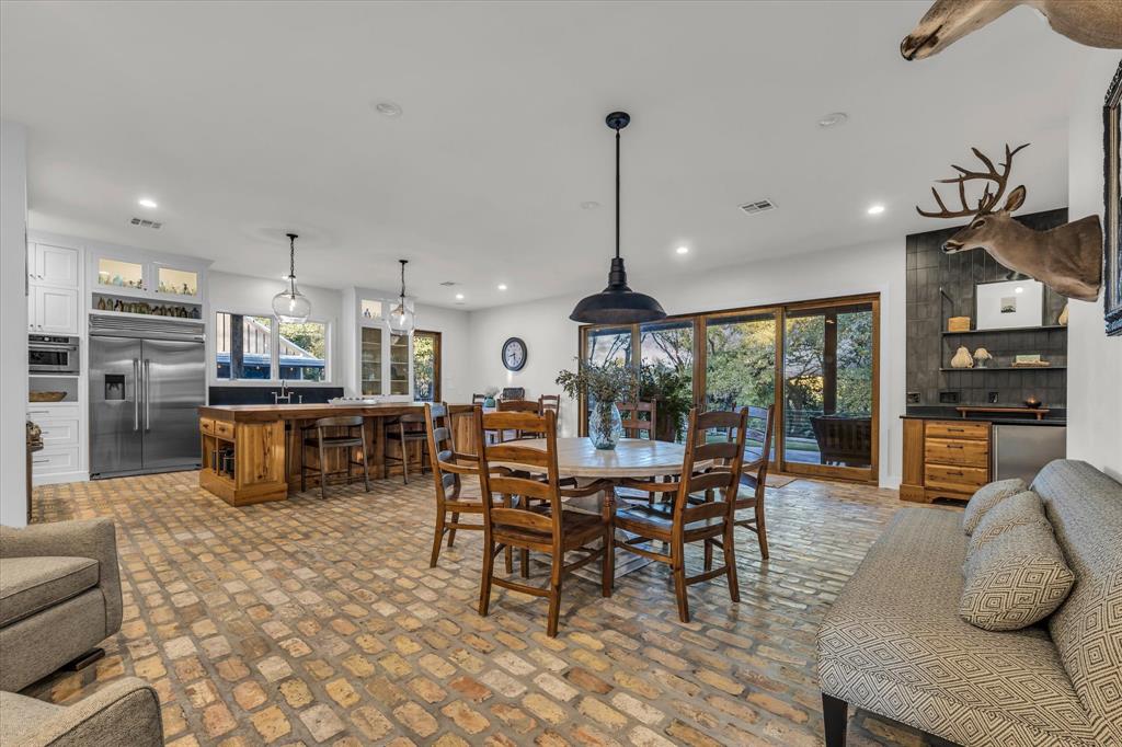 22 Samaritan Way Waco, TX 76705 - Photo 9 of 38 a kitchen with stainless steel appliances kitchen island granite top and refrigerator