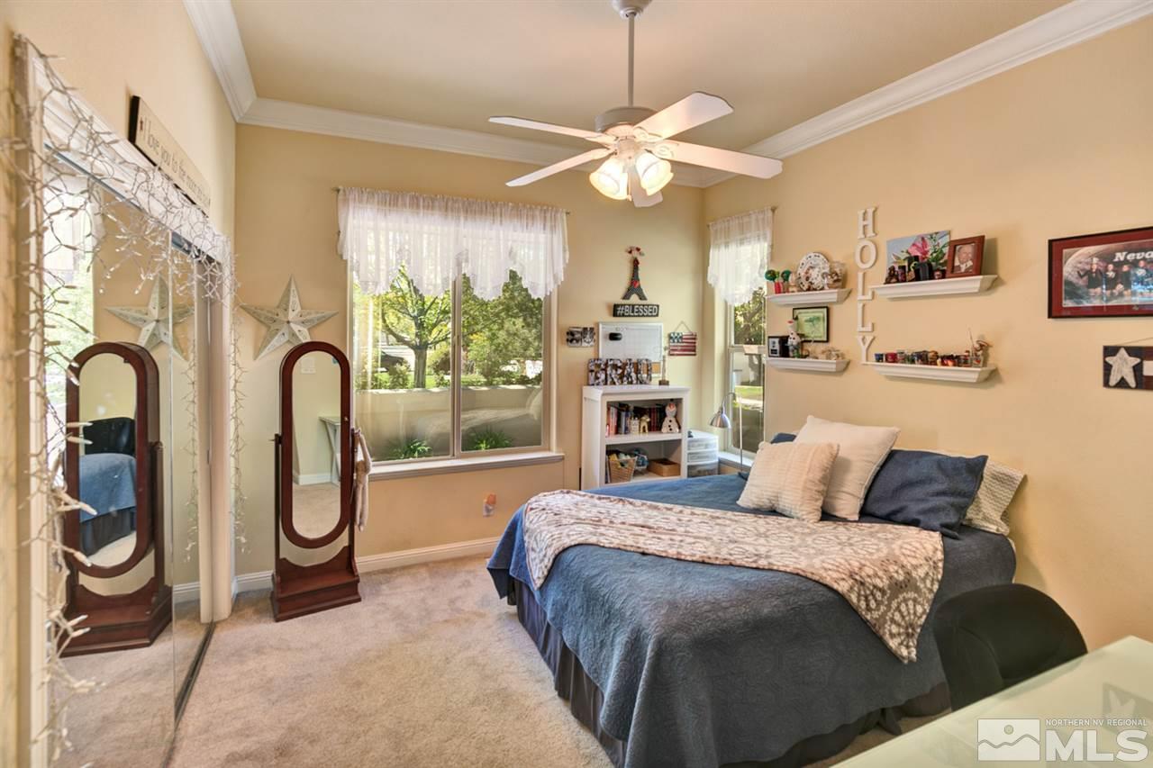 5610 Rivers Edge Drive Fallon, NV 89406 - Photo 12 of 25 a bedroom with a bed and a chandelier