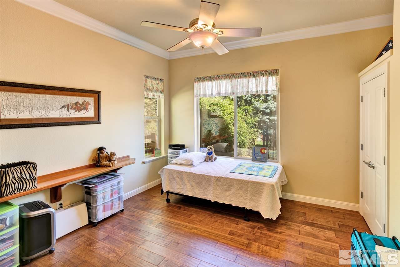 5610 Rivers Edge Drive Fallon, NV 89406 - Photo 15 of 25 a bedroom with a bed and a chandelier