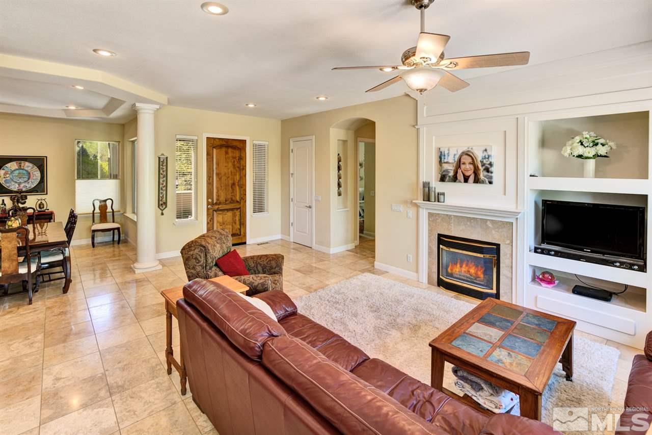 5610 Rivers Edge Drive Fallon, NV 89406 - Photo 7 of 25 a living room with furniture a flat screen tv and a fireplace