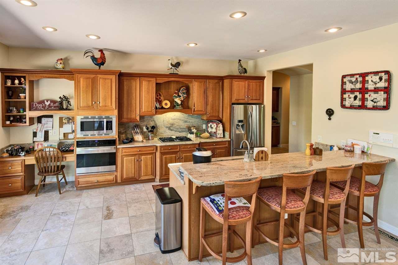 5610 Rivers Edge Drive Fallon, NV 89406 - Photo 8 of 25 a kitchen with stainless steel appliances kitchen island granite countertop a sink and cabinets