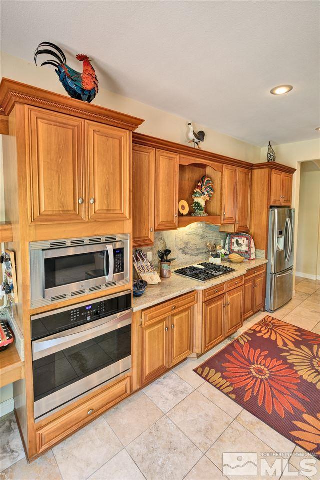 5610 Rivers Edge Drive Fallon, NV 89406 - Photo 9 of 25 a kitchen with stainless steel appliances granite countertop a stove and a sink