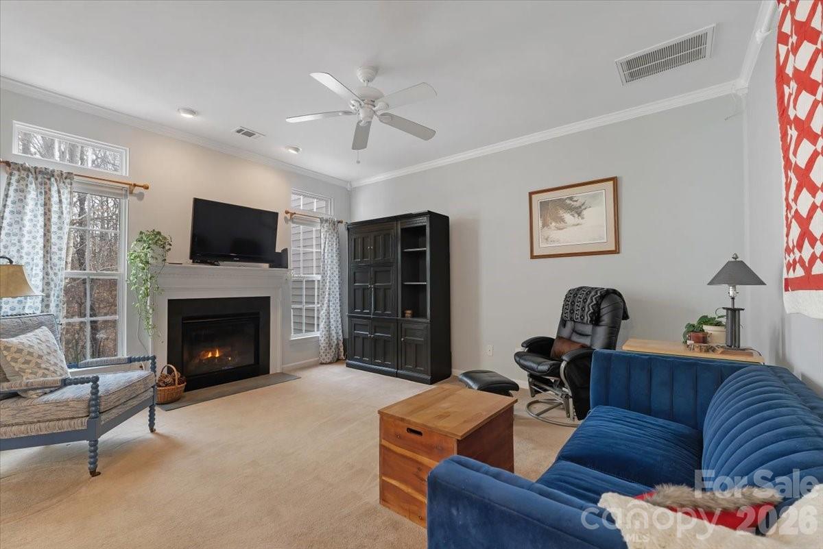 7948 Mariners Pointe Circle Denver, NC 28037 - Photo 15 of 39 a living room with furniture a fireplace and a flat screen tv