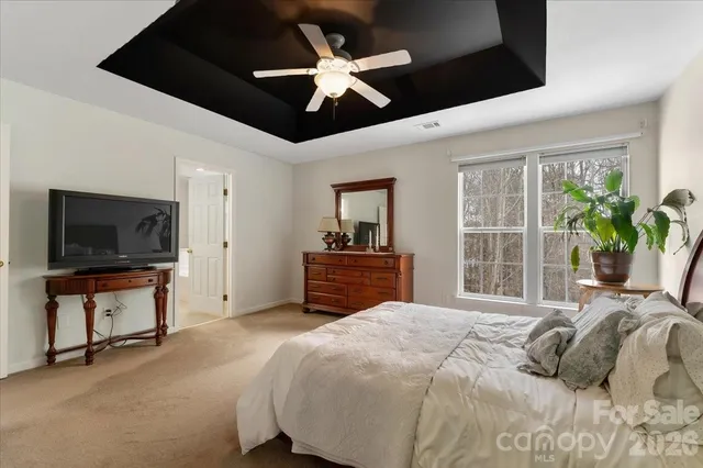 a bedroom with a large bed and a tv