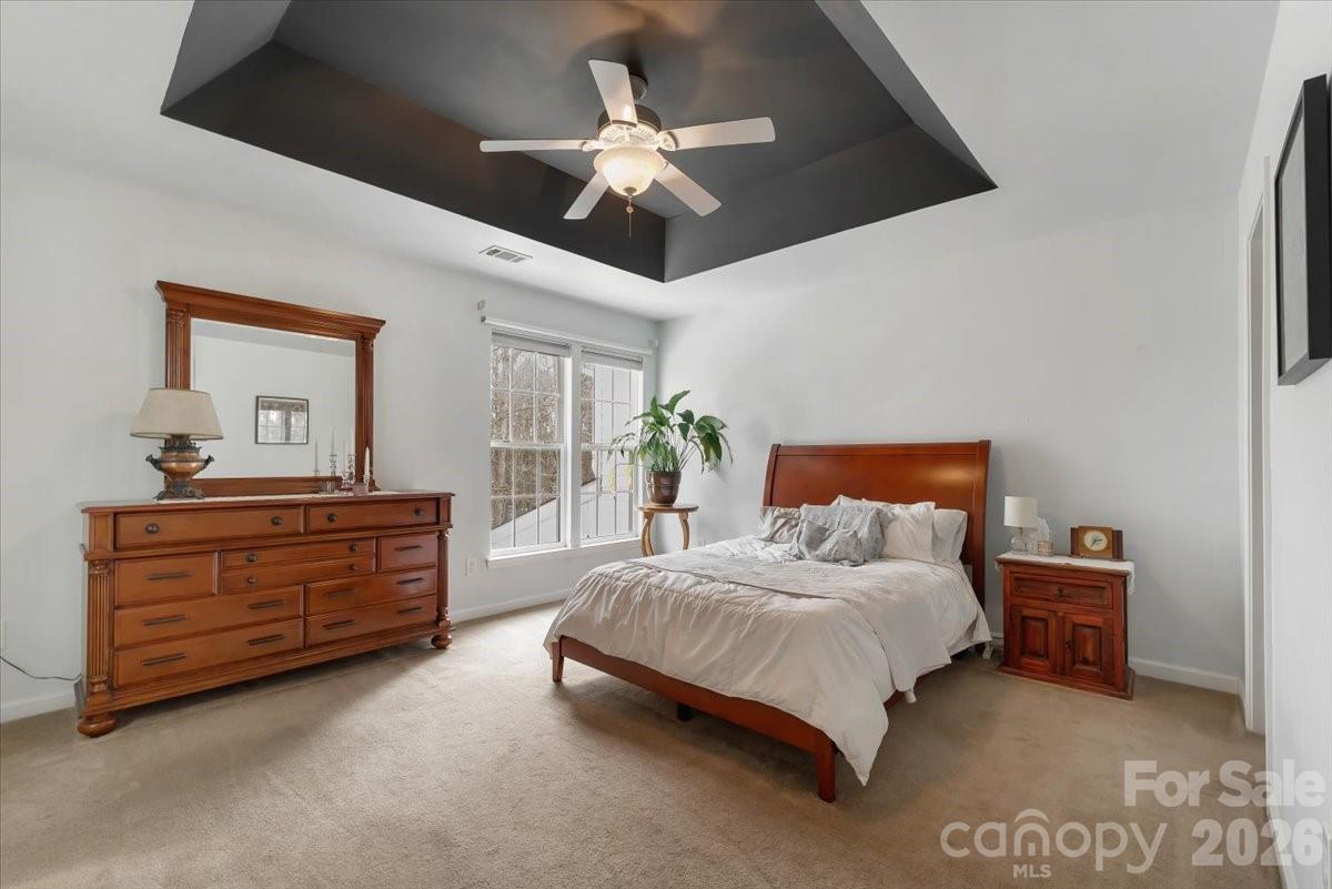 7948 Mariners Pointe Circle Denver, NC 28037 - Photo 21 of 39 a bedroom with a bed chandelier and dresser