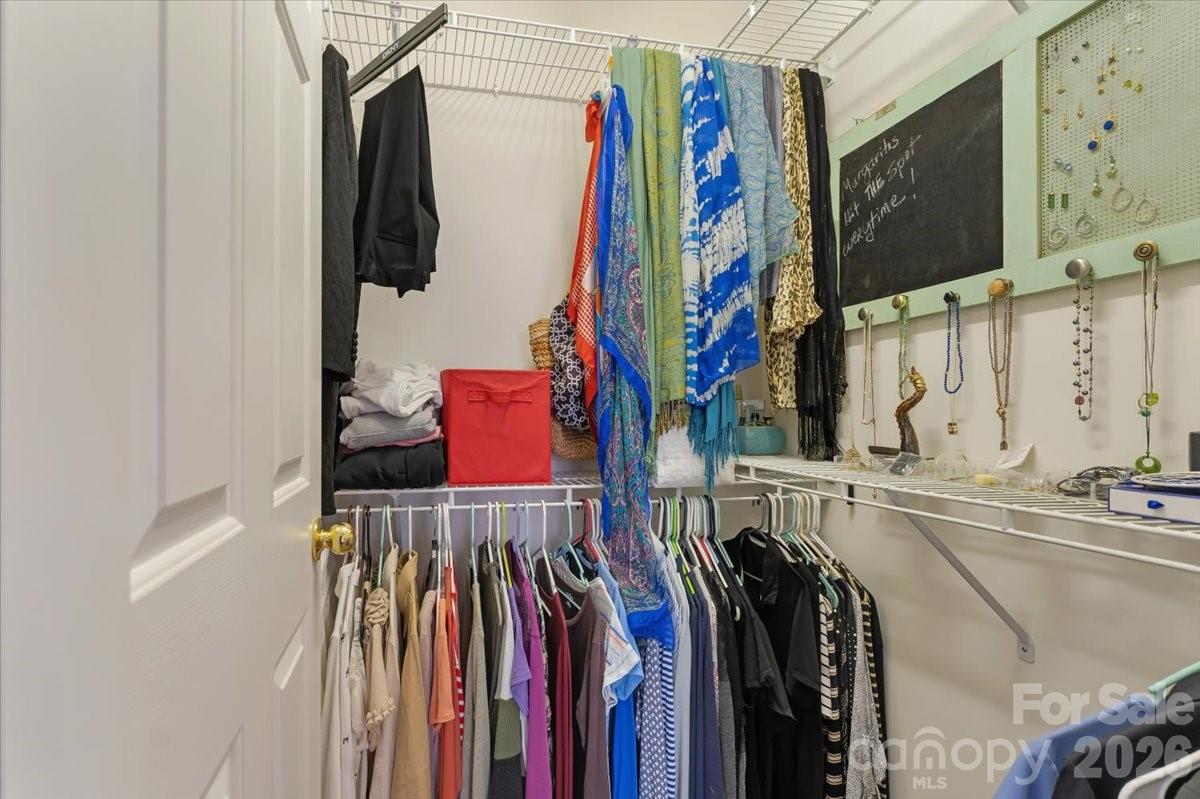 7948 Mariners Pointe Circle Denver, NC 28037 - Photo 22 of 39 a view of walk in closet with clothes and shoes
