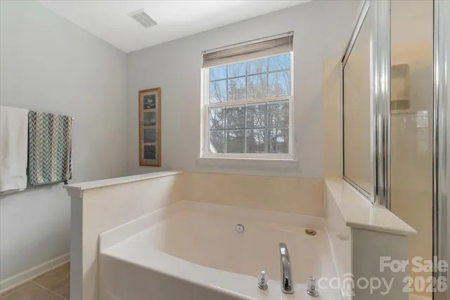 a white bath tub sitting next to a window