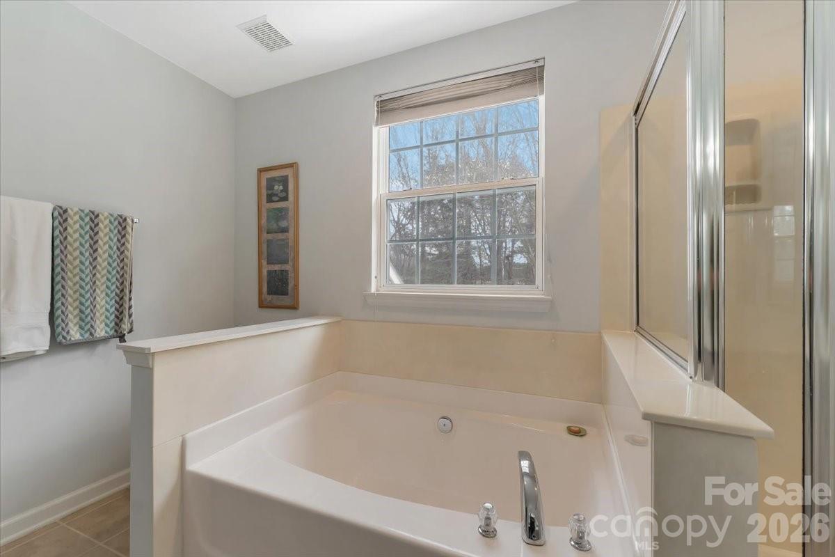 7948 Mariners Pointe Circle Denver, NC 28037 - Photo 25 of 39 a white bath tub sitting next to a window