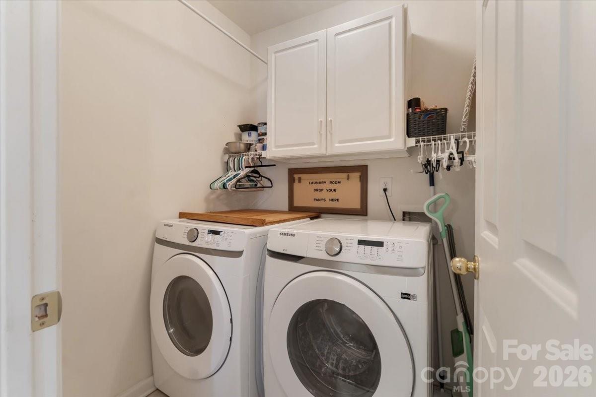 7948 Mariners Pointe Circle Denver, NC 28037 - Photo 32 of 39 a view of washer and dryer with kitchen in the background