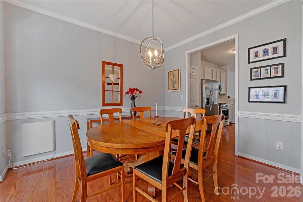 7948 Mariners Pointe Circle Denver, NC 28037 - Photo 4 of 39 a view of a dining room with furniture and wooden floor