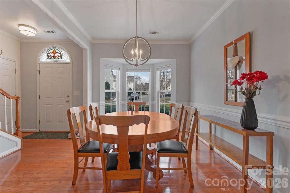 7948 Mariners Pointe Circle Denver, NC 28037 - Photo 5 of 39 a view of a dining room with furniture wooden floor and chandelier