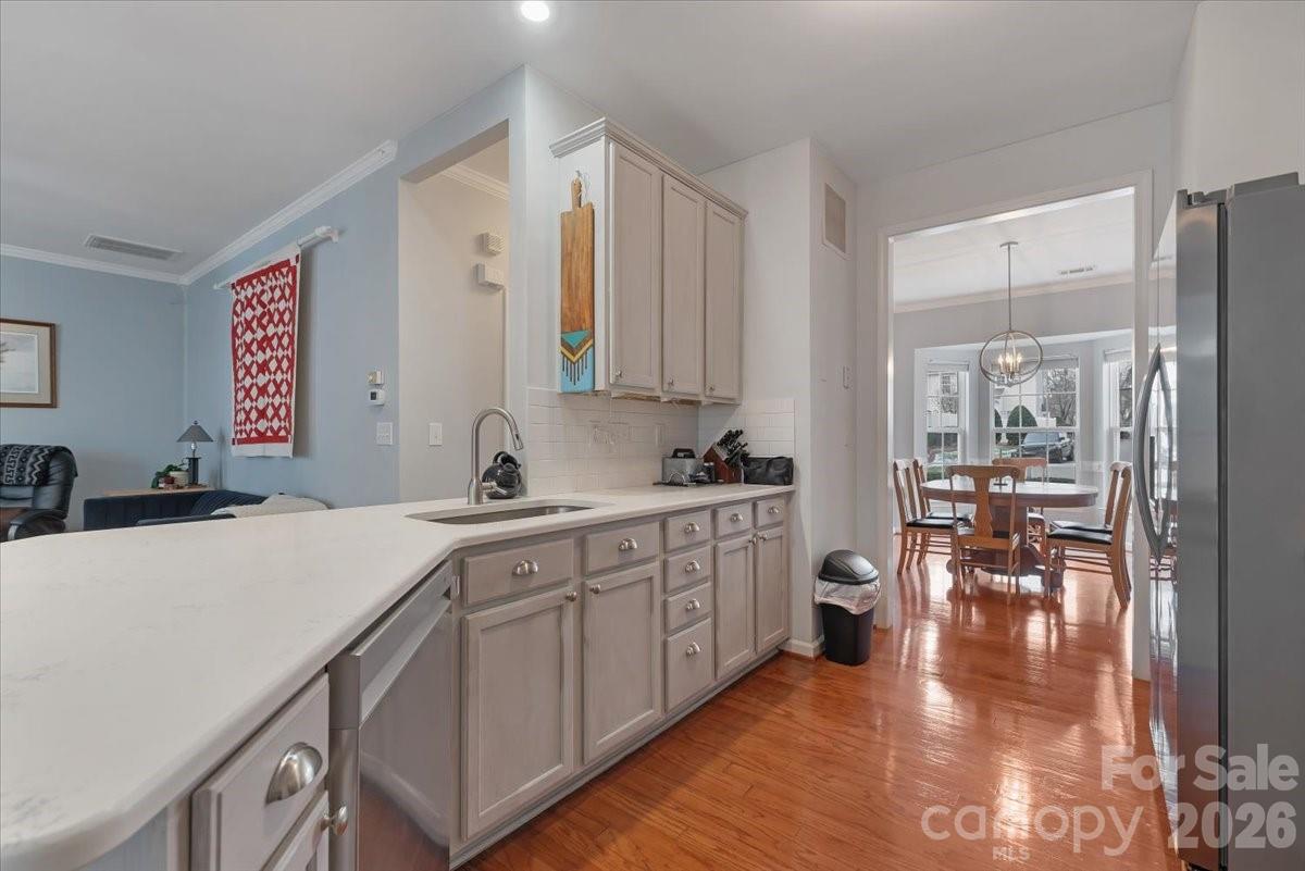 7948 Mariners Pointe Circle Denver, NC 28037 - Photo 6 of 39 a kitchen with a sink cabinets and wooden floor