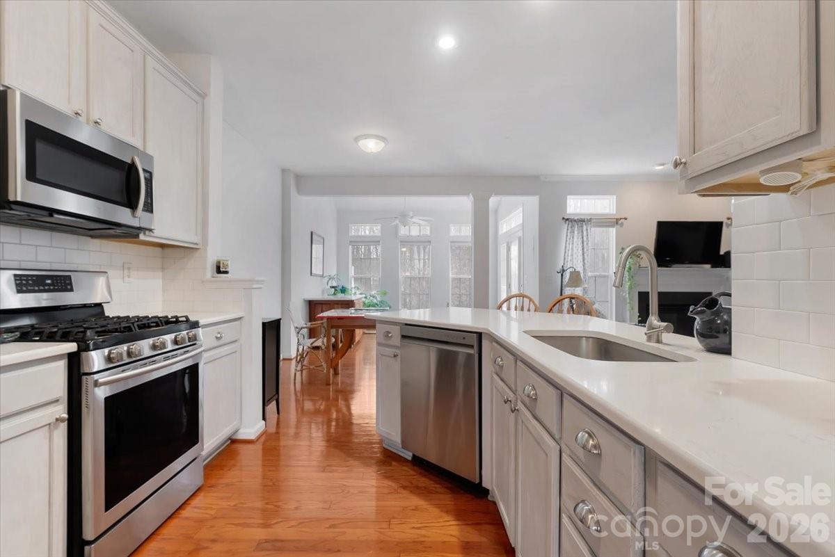 7948 Mariners Pointe Circle Denver, NC 28037 - Photo 7 of 39 a kitchen with stainless steel appliances granite countertop a sink stove microwave and refrigerator