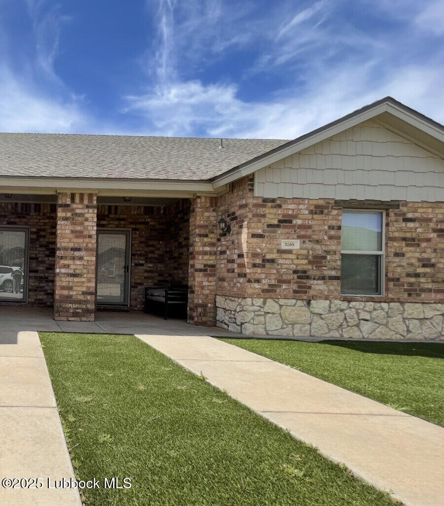 3205 112th Street Lubbock, TX 79423 - Photo 1 of 19 a front view of a house with a yard