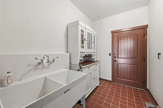 a kitchen with granite countertop a refrigerator stove and sink