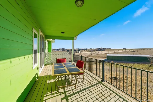 a balcony with furniture and a garden