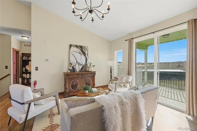 a living room with furniture a window and glass door