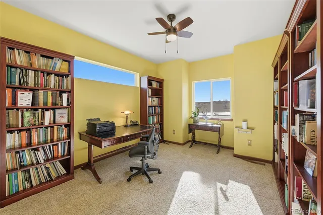 a view of a livingroom with workspace and a window