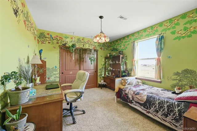 a bedroom with bed and a chandelier