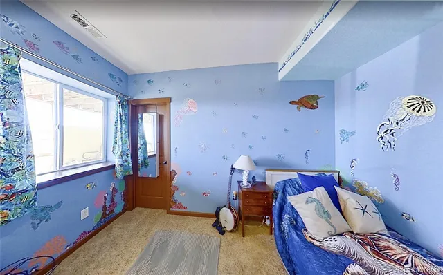 a bed room with a bed and a window